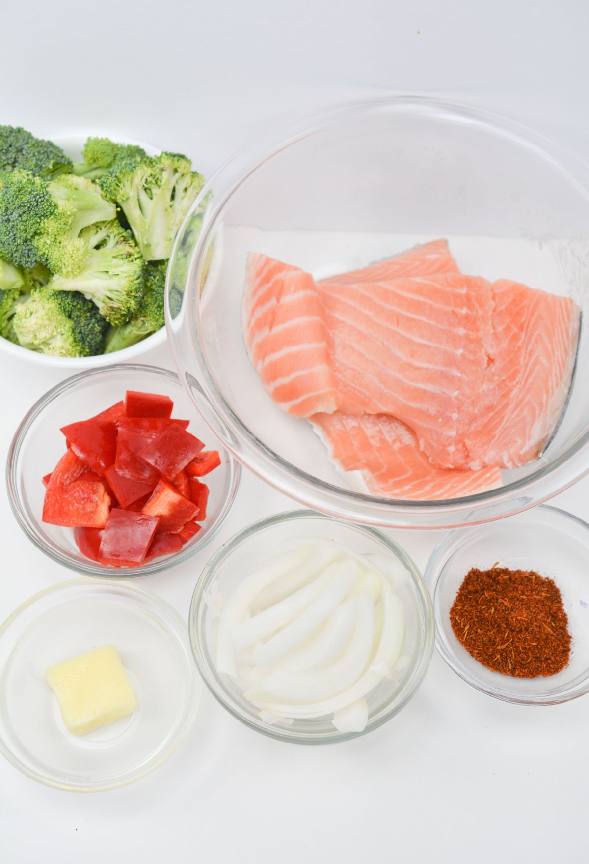 The ingredients for blackened salmon and broccoli in a bowl.