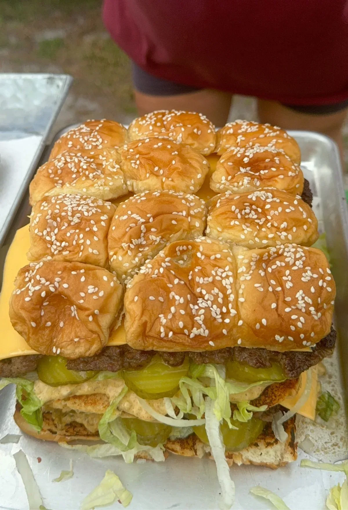 A large burger on a tray.