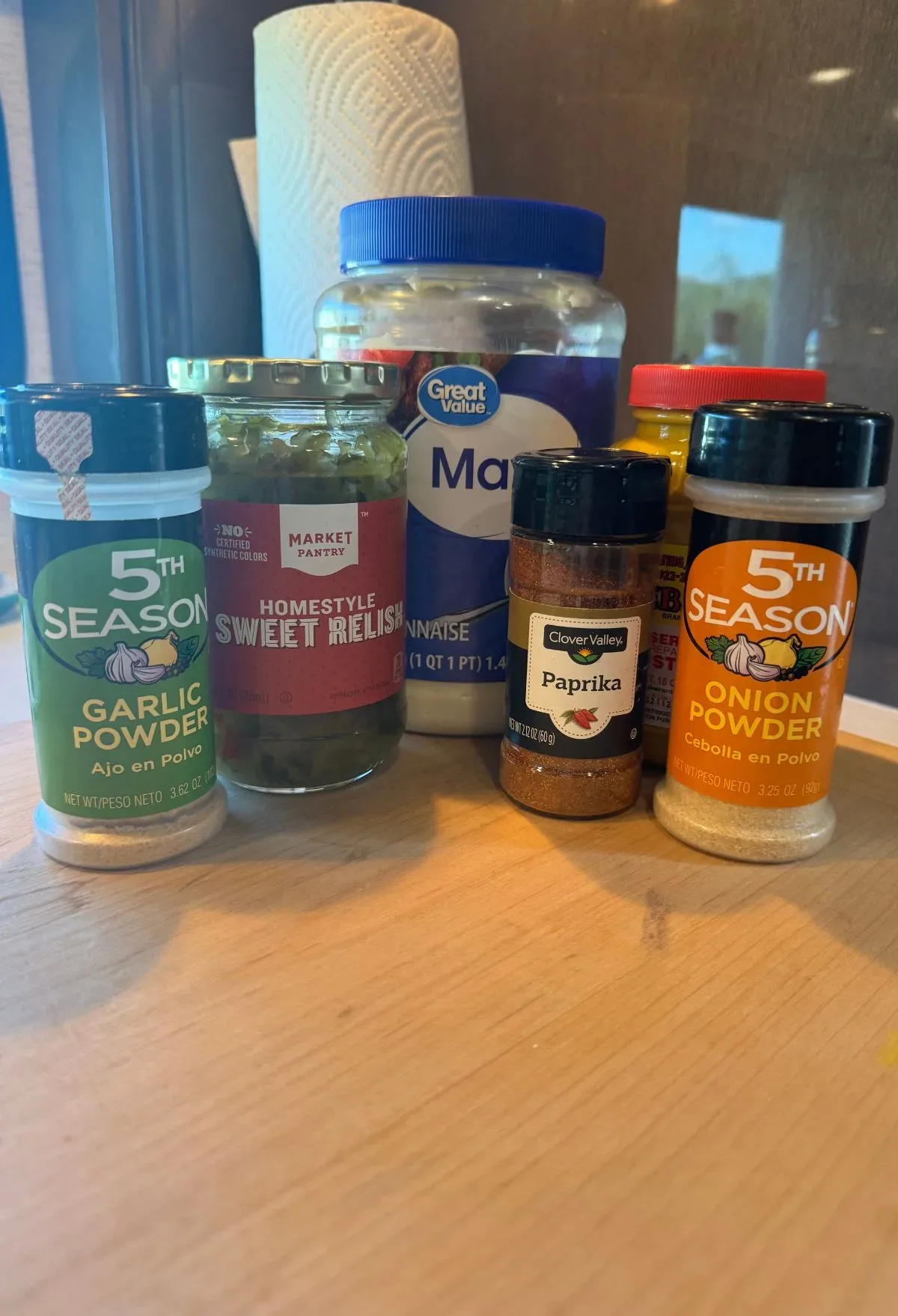 Spices and seasonings on a wooden table.