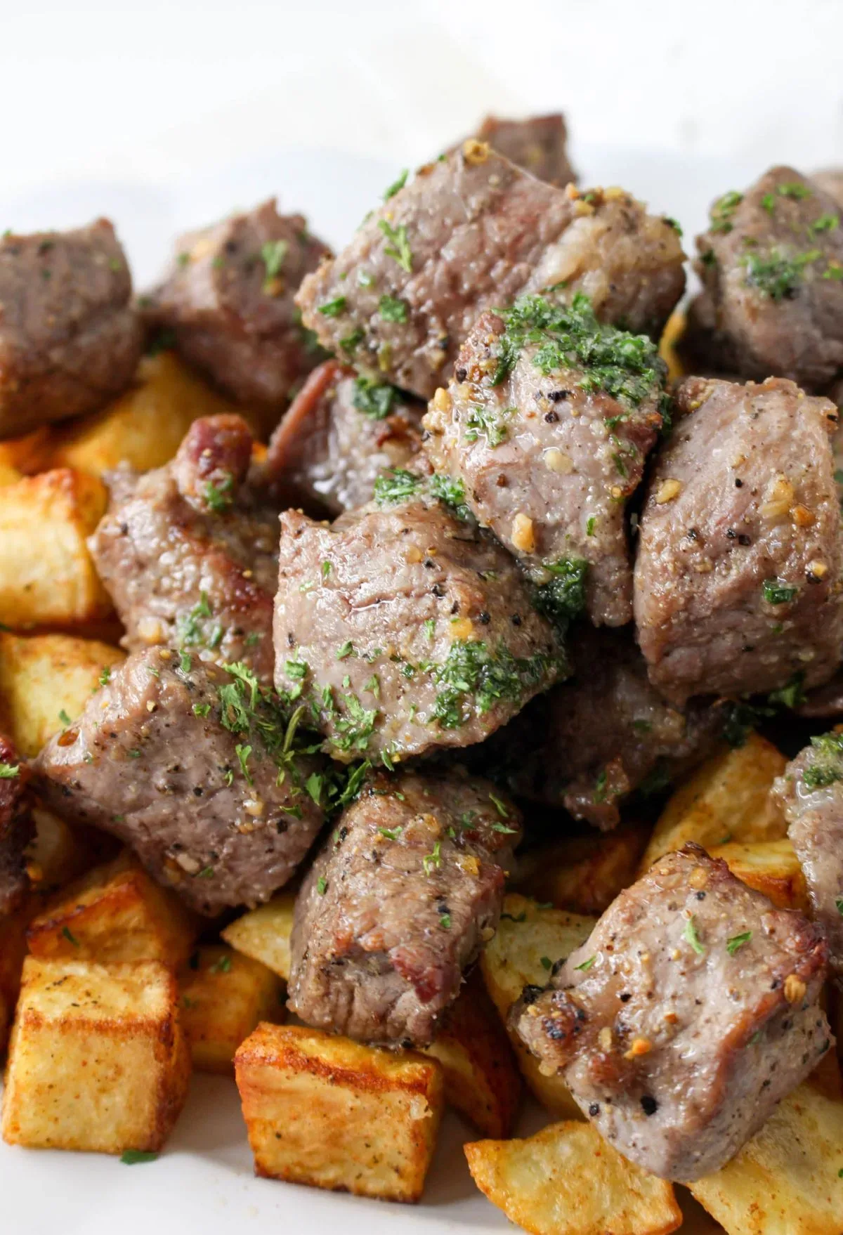 A plate with meat and potatoes on it.